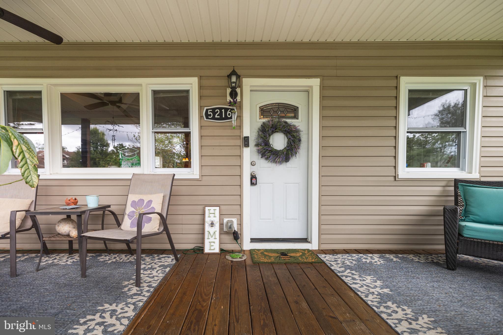 5216 Tramore Road Baltimore, MD 21214 - Photo 33 of 39 a view of a porch with a table and chairs and wooden floor