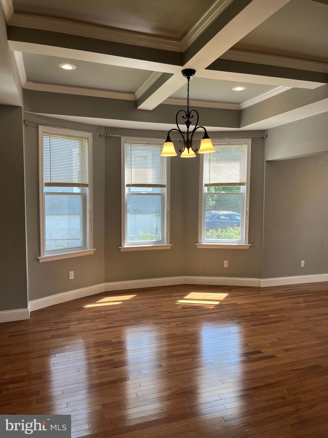 5216 Tramore Road Baltimore, MD 21214 - Photo 6 of 39 a view of an empty room with wooden floor and a window