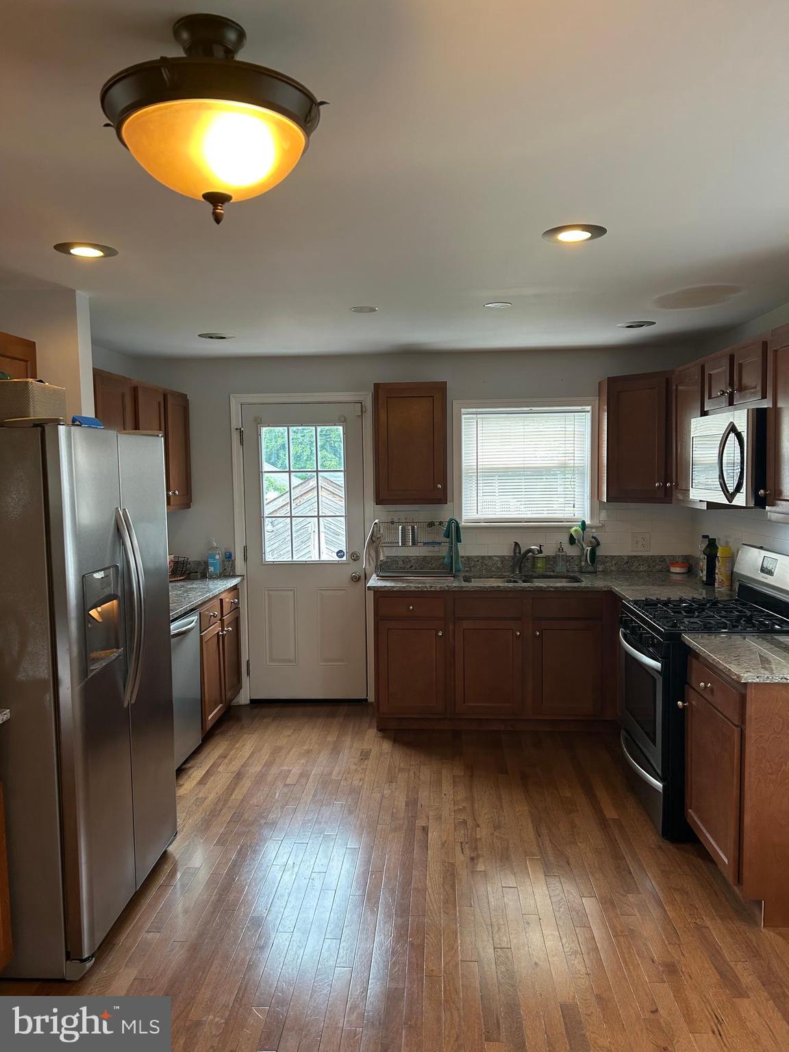 5216 Tramore Road Baltimore, MD 21214 - Photo 8 of 39 a kitchen with stainless steel appliances granite countertop a stove a sink a refrigerator and microwave