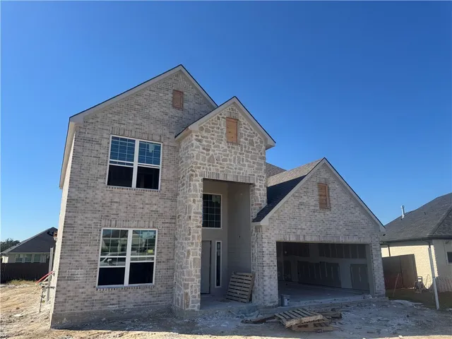 a front view of a house with a garage
