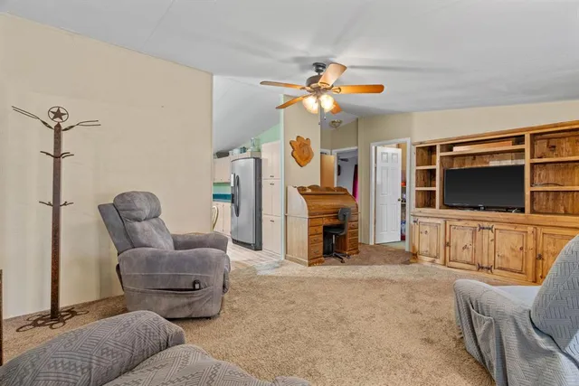 a kitchen with stainless steel appliances granite countertop a stove top oven a sink dishwasher and a refrigerator with wooden floor