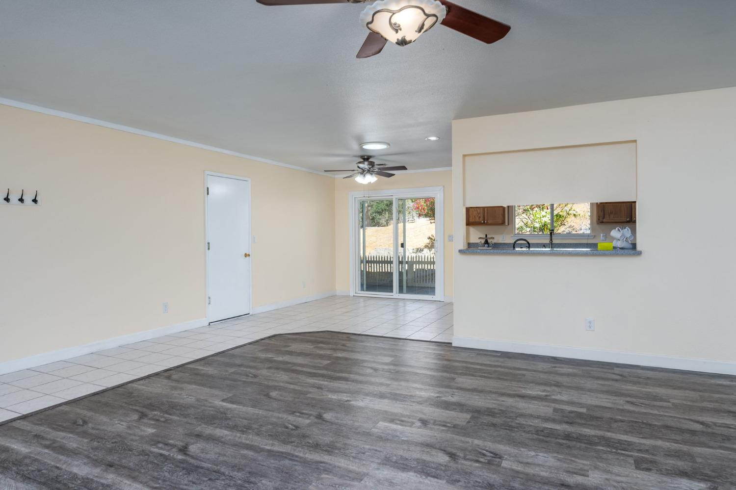 44909 Person Loop North Coarsegold, CA 93614 - Photo 12 of 32 a view of a room with wooden floor and ceiling fan