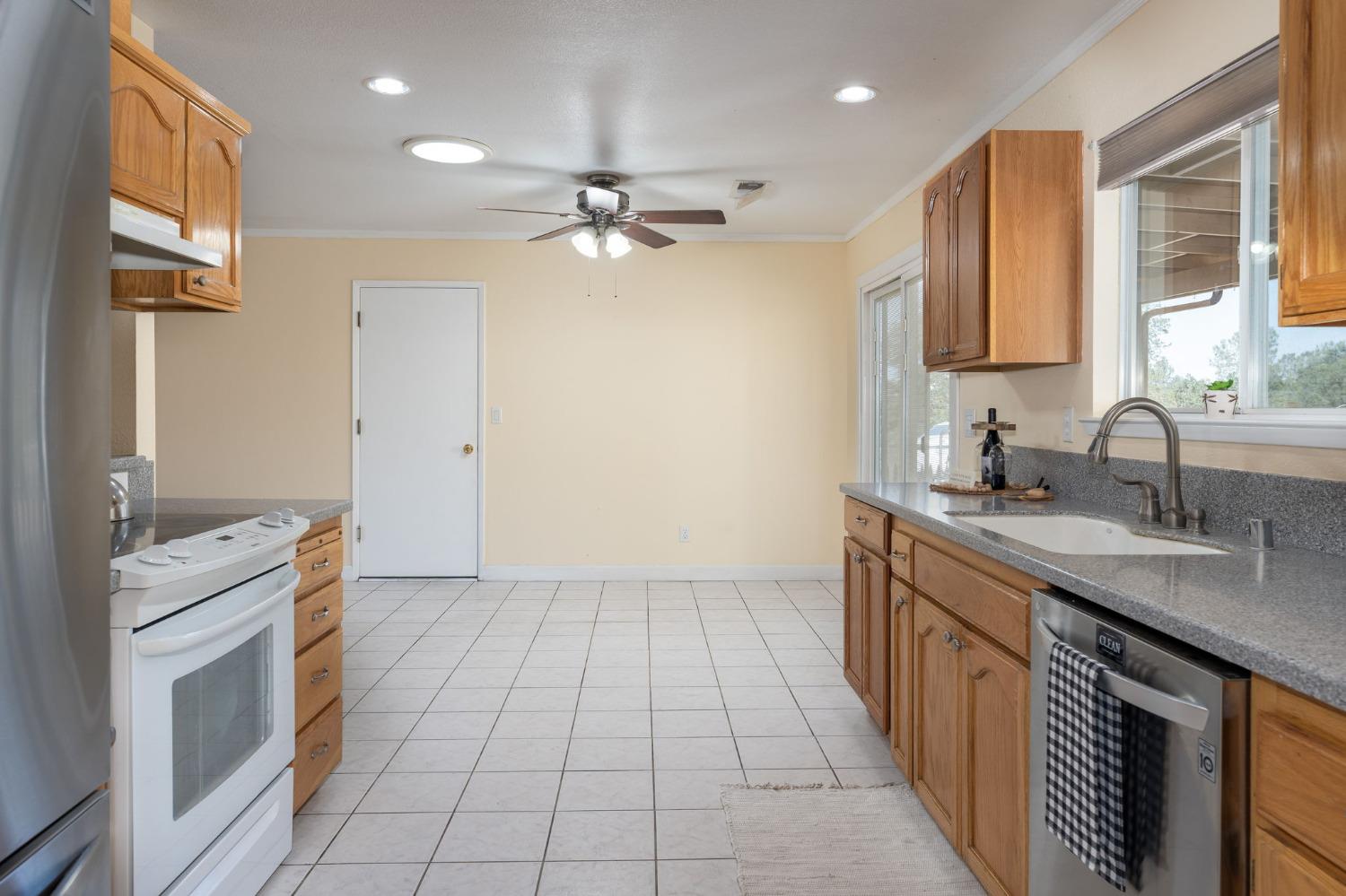 44909 Person Loop North Coarsegold, CA 93614 - Photo 15 of 32 a kitchen with a sink appliances and cabinets