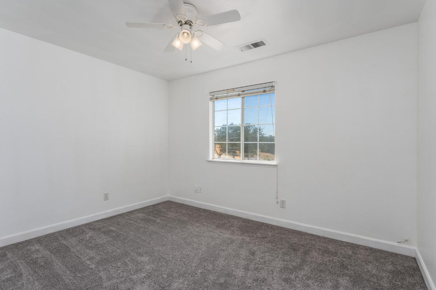 44909 Person Loop North Coarsegold, CA 93614 - Photo 21 of 32 an empty room with a window and a fan