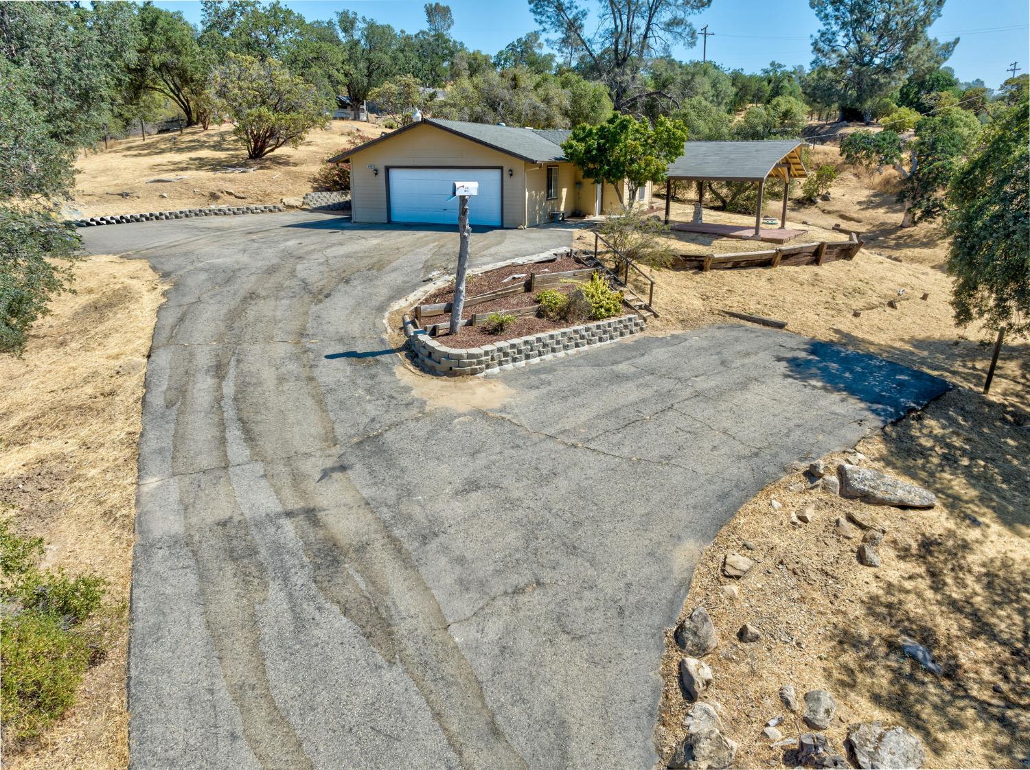 44909 Person Loop North Coarsegold, CA 93614 - Photo 3 of 32 a front view of a house with a yard