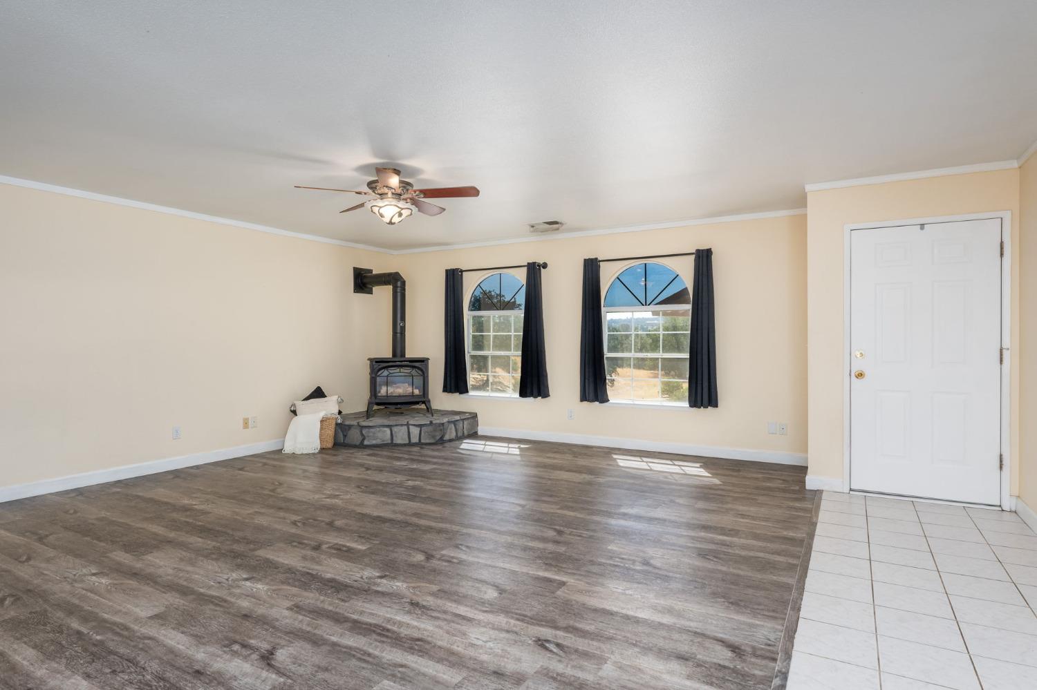 44909 Person Loop North Coarsegold, CA 93614 - Photo 9 of 32 a view of an empty room with window and wooden floor