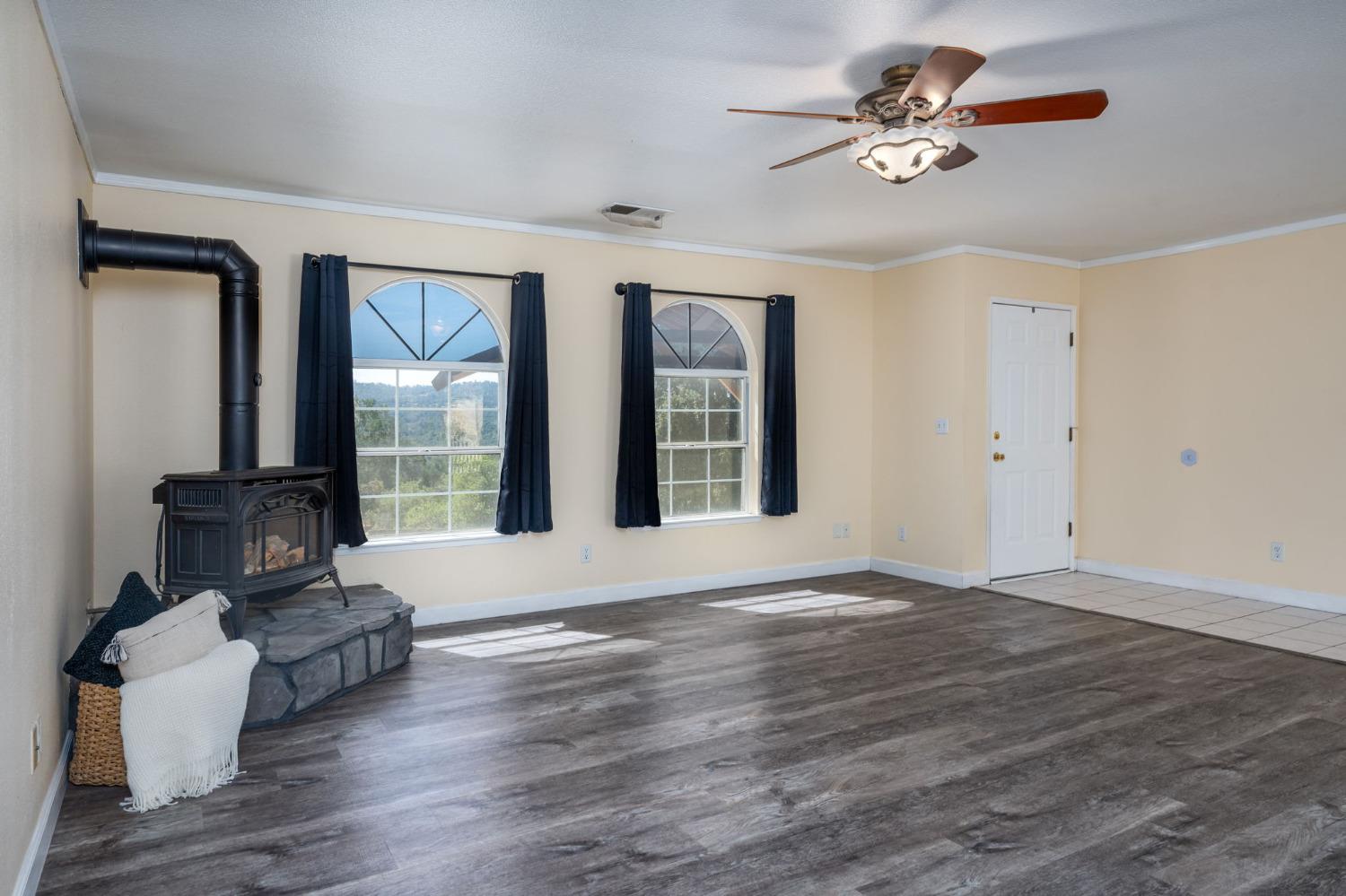 44909 Person Loop North Coarsegold, CA 93614 - Photo 10 of 32 a view of an empty room with a window and wooden floor