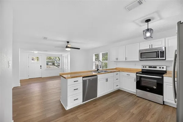 a kitchen with stainless steel appliances a stove top oven and sink