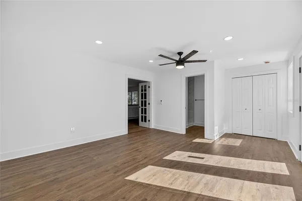 a bedroom with a bed and a ceiling fan