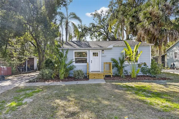 a view of the house with a tree in the background