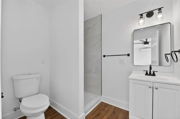 a bathroom with a sink toilet and vanity