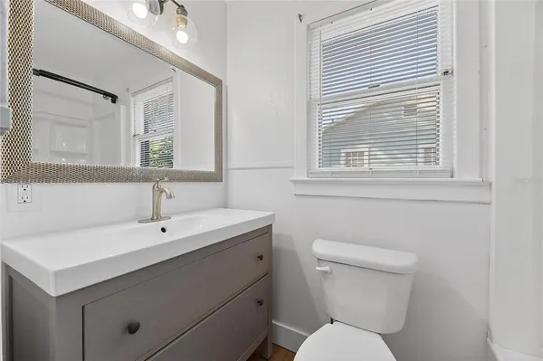 a white bath tub sitting next to a shower