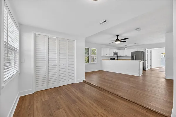 a view of a kitchen with wooden floor and a kitchen space