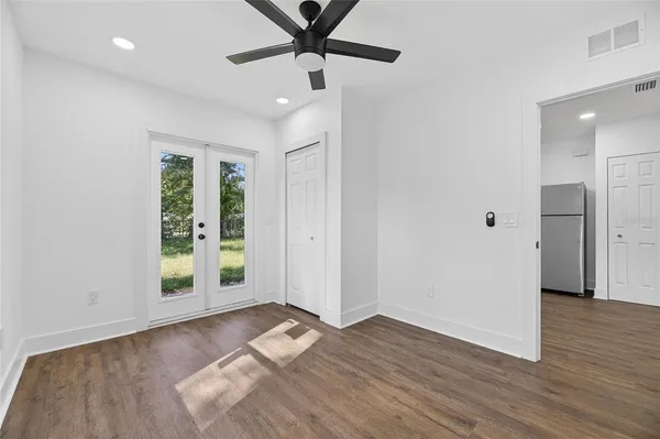 a view of empty room with wooden floor