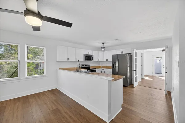 a kitchen with stainless steel appliances a refrigerator and a stove top oven