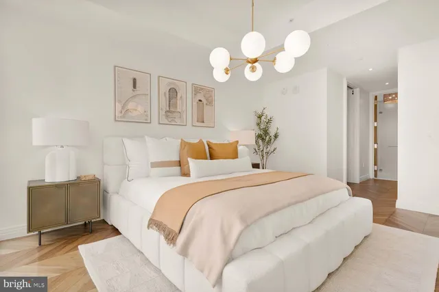 a bedroom with a bed and a chandelier