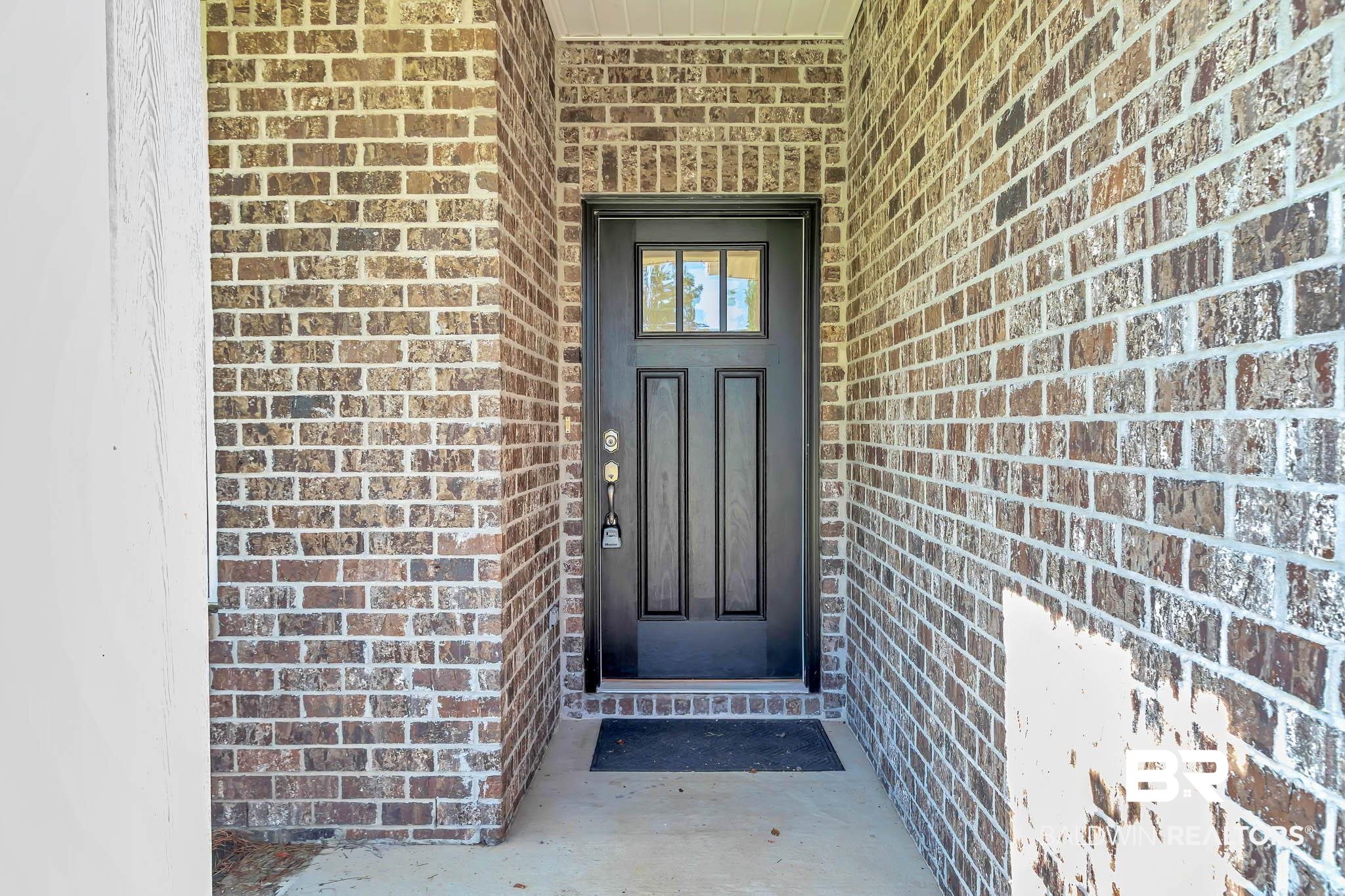 16461 Prado Loop Loxley, AL 36551 - Photo 26 of 78 Doorway to property with brick siding
