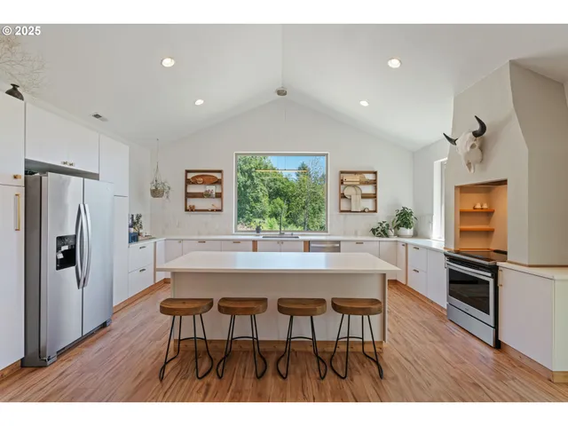 a kitchen with stainless steel appliances a refrigerator and a stove
