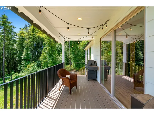 a balcony with wooden floor table and chairs