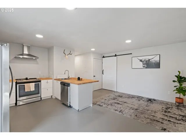 a kitchen with a refrigerator and a stove top oven
