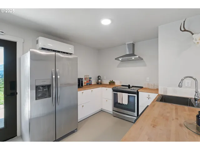 a kitchen with stainless steel appliances kitchen island a refrigerator sink and stove