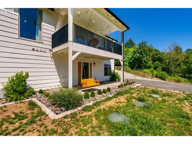 a view of a house with backyard and sitting area