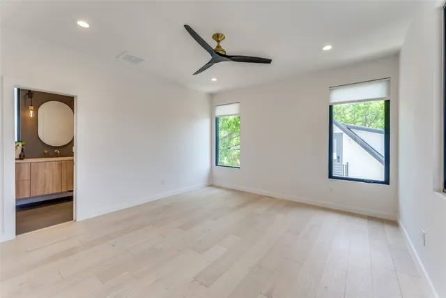a bedroom with a large bed and a large window