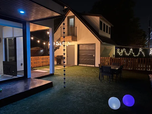 an aerial view of a city with lots of residential buildings ocean and mountain view in back