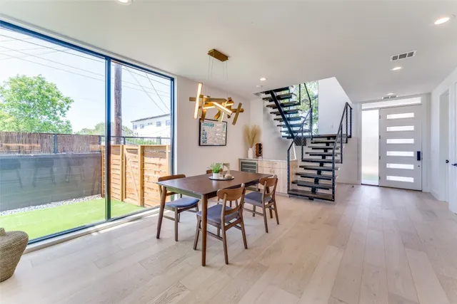 a dining room with furniture and wooden floor