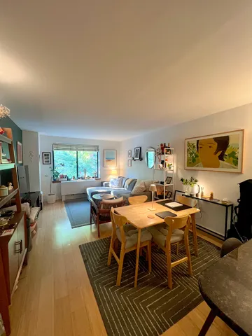 a dining room with furniture and wooden floor