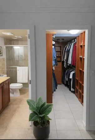 a bed room with a bed and a potted plant