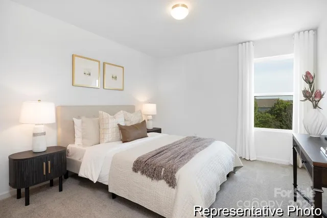 a bed room with a bed and a chair