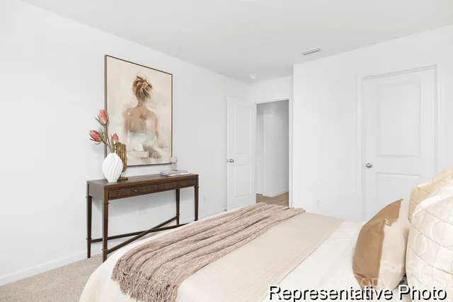 a bedroom with a bed and a painting on the wall