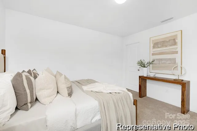 a bedroom with a bed and a potted plant