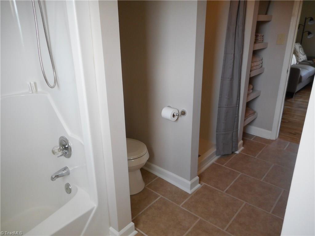 6346 Company Mill Road Climax, NC 27233 - Photo 27 of 30 In this view we are in the main hall bathroom on the second floor. Here we have tile flooring for easy cleaning, fresh new paint, a tub and a separate shower and a window for natural lighting.