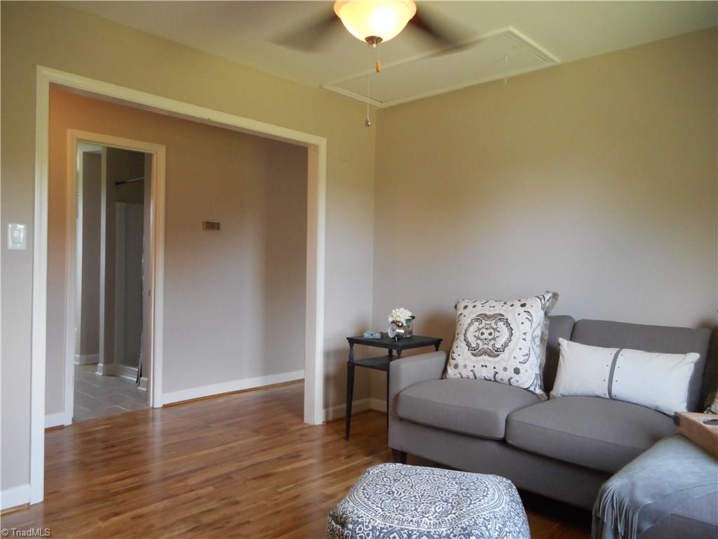 6346 Company Mill Road Climax, NC 27233 - Photo 28 of 30 In this view we are in the second floor sitting room. Nice quiet spot to get away from the crowd downstairs and chill out on a busy day. Here we have engineered wood flooring, fresh new paint, a ceiling fan with light and a window for natural lighting.