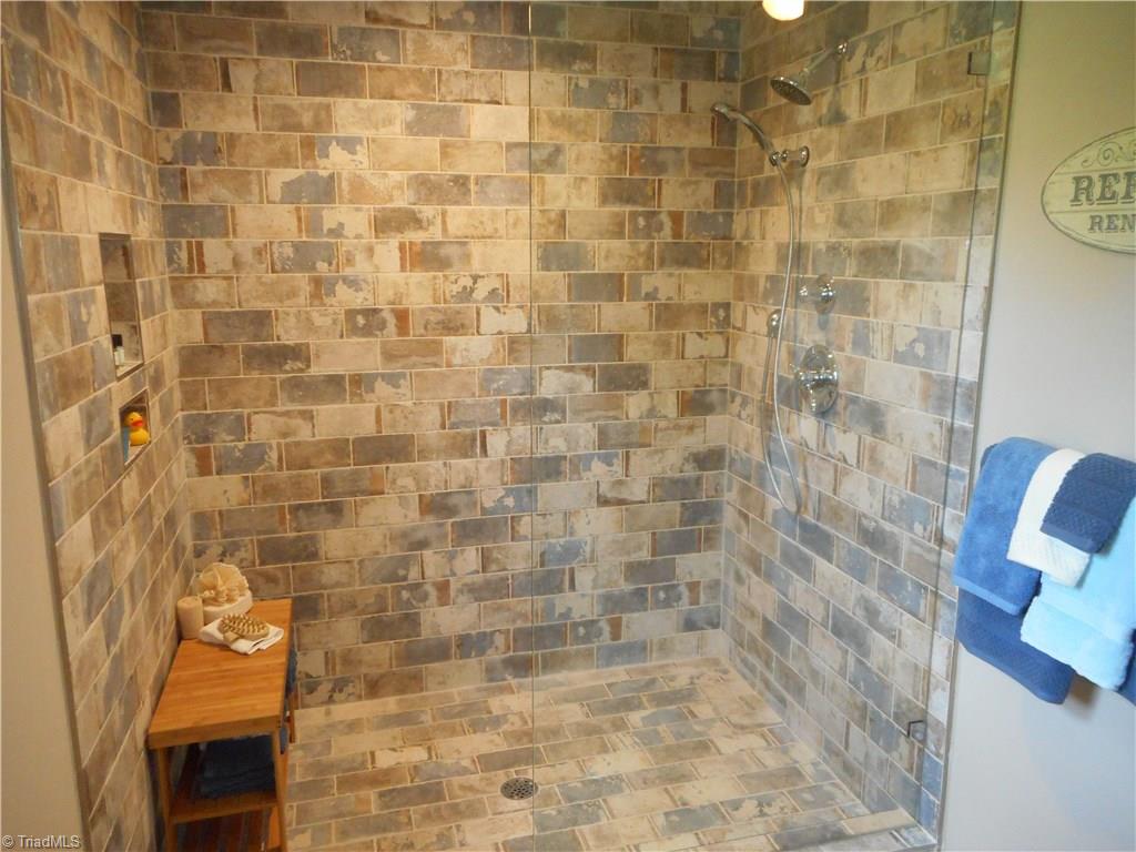 6346 Company Mill Road Climax, NC 27233 - Photo 6 of 30 In this view we can see the separate shower with decorative tile and half glass shower door.