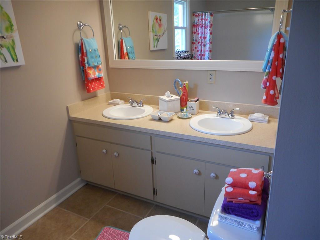 6346 Company Mill Road Climax, NC 27233 - Photo 8 of 30 In this view we are in the full sized bathroom from bedroom two. Here we have the double vanity sinks, the new fixtures and the fresh new paint. This bathroom has a tub / shower.