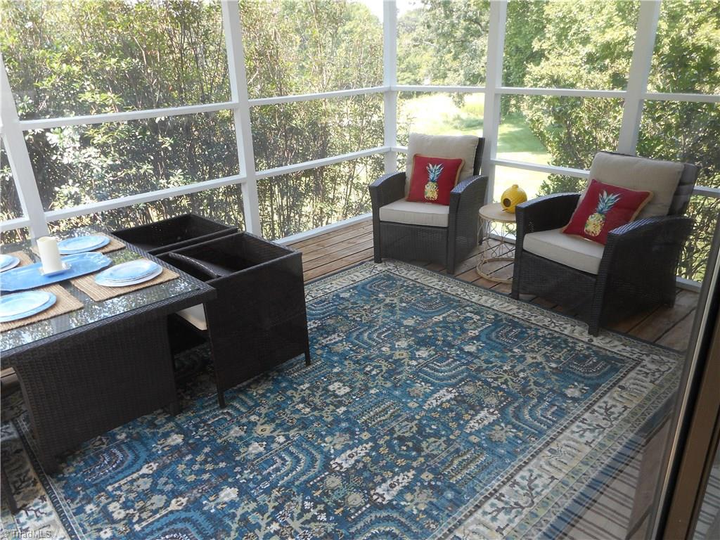 6346 Company Mill Road Climax, NC 27233 - Photo 9 of 30 In this view we are in the den / kitchen area looking into the screened in porch. I see you have the table set for a casual relaxing dinner. Awesome.
