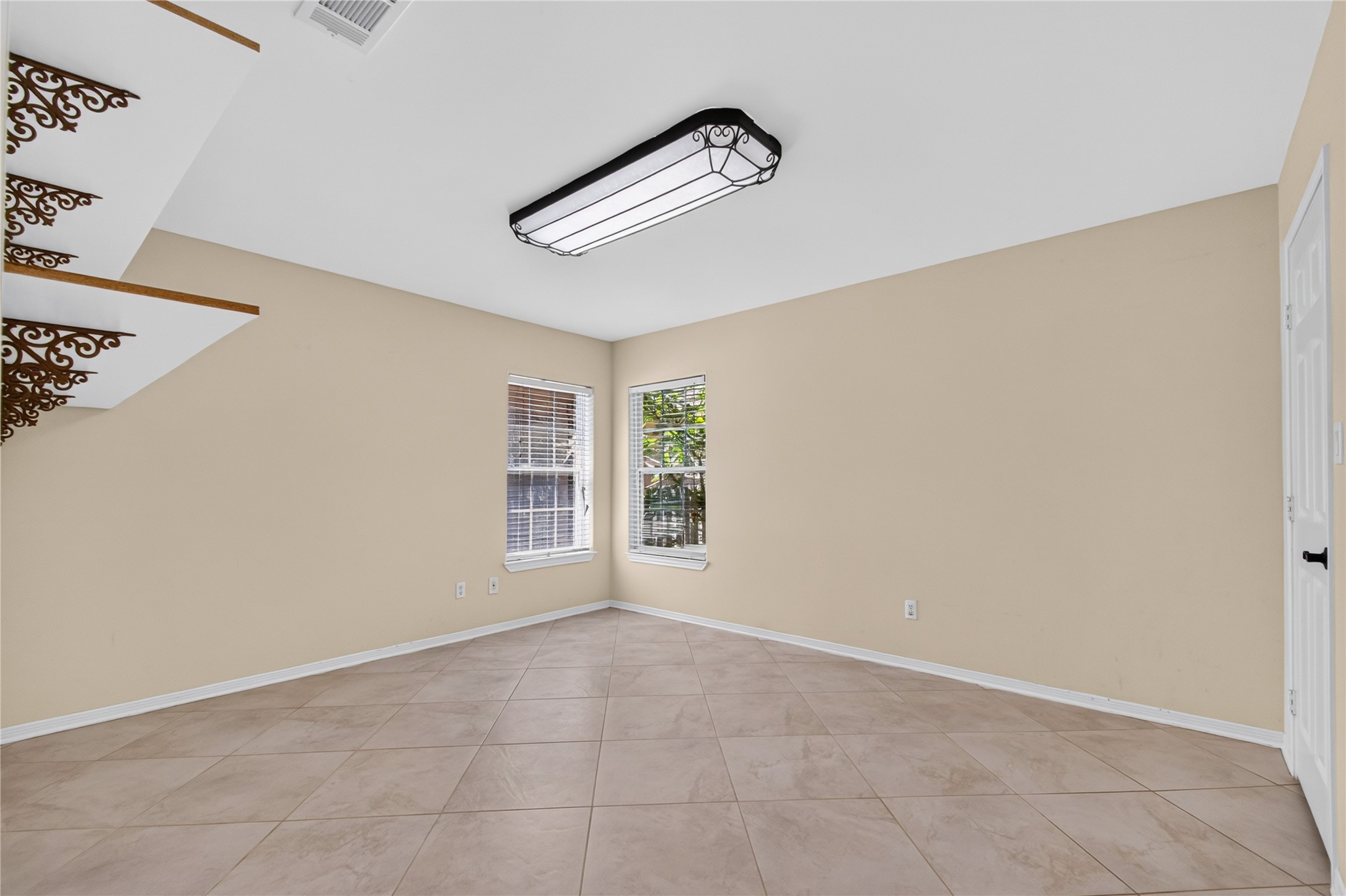 20203 Timber Ridge Drive Magnolia, TX 77355 - Photo 18 of 49 Spacious secondary bedroom with neutral paint, easy-care tile flooring, and two large windows that fill the room with natural light.