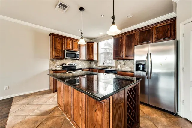 a kitchen that has a stove a sink a window and a counter top space