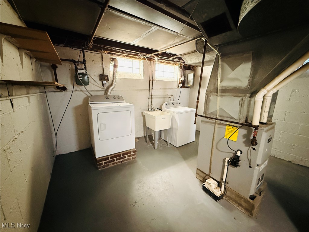 5239 Arch Street Maple Heights, OH 44137 - Photo 19 of 25 Below grade area with washer and clothes dryer and heating unit