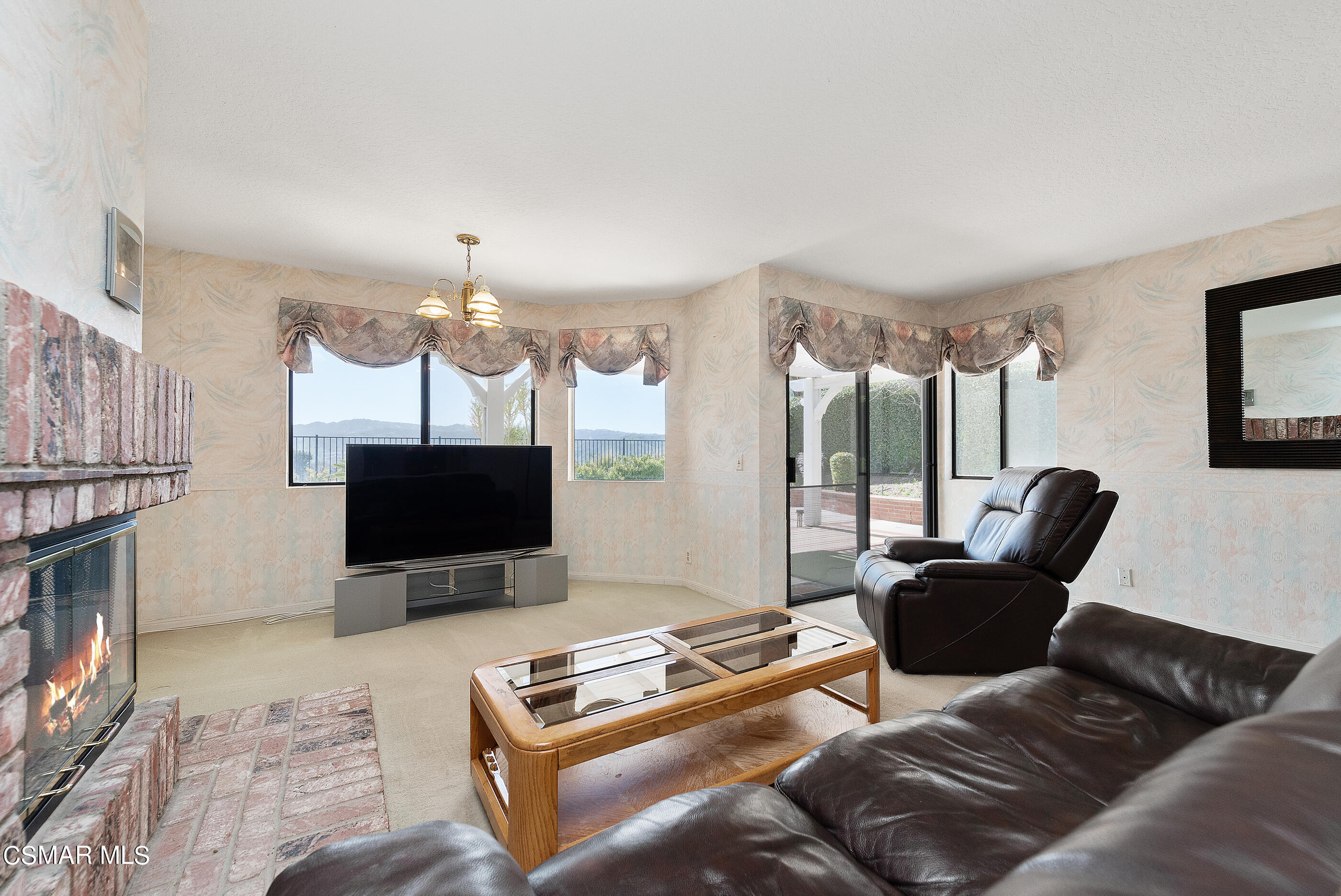 Undisclosed Address Simi Valley, CA 93063 - Photo 20 of 69 a living room with furniture a flat screen tv and a fireplace