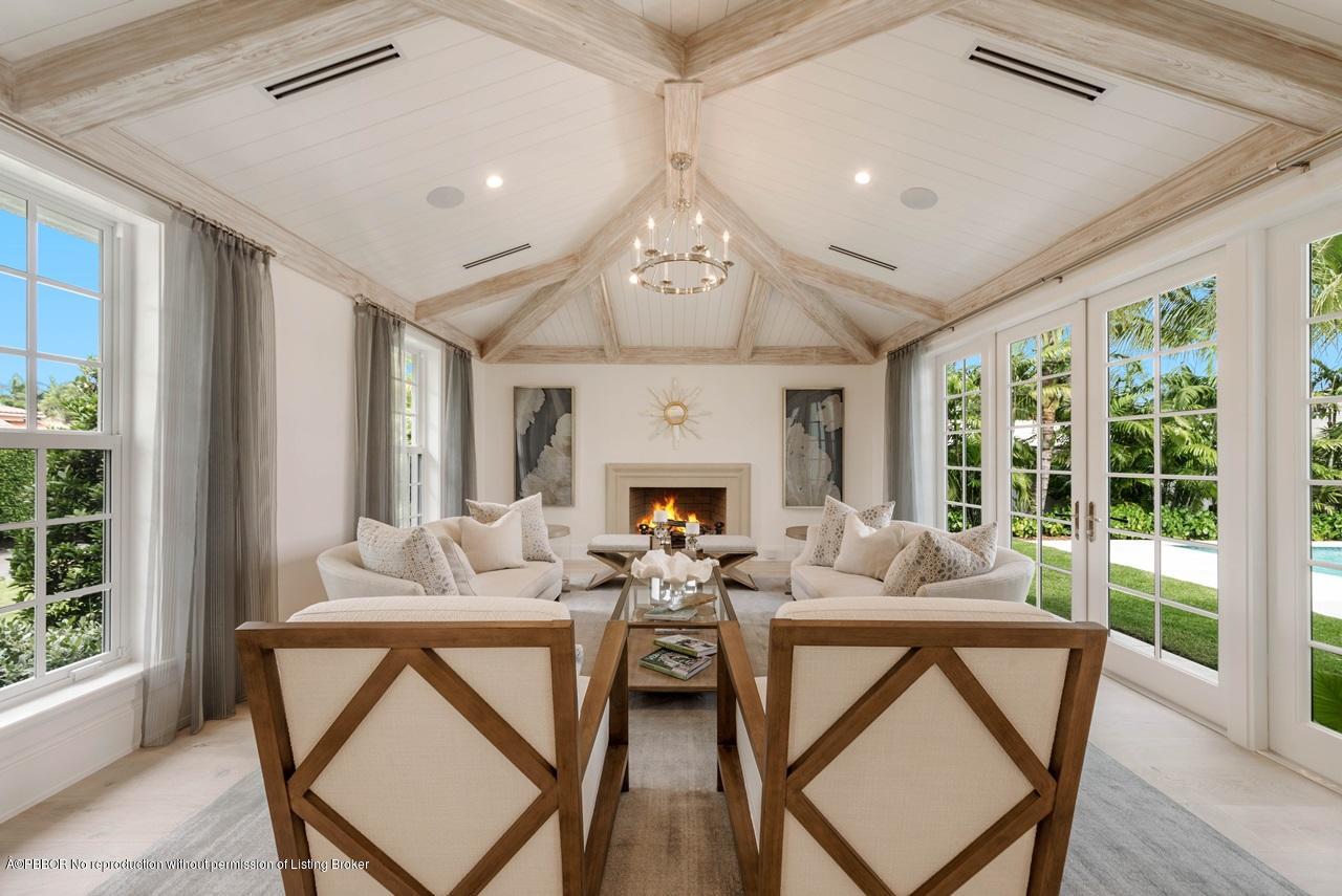 225 Arabian Road Palm Beach, FL 33480 - Photo 3 of 14 a living room with furniture a fireplace and a large window