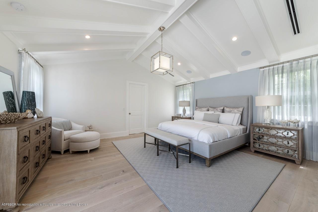 225 Arabian Road Palm Beach, FL 33480 - Photo 8 of 14 a spacious bedroom with a bed and ceiling fan