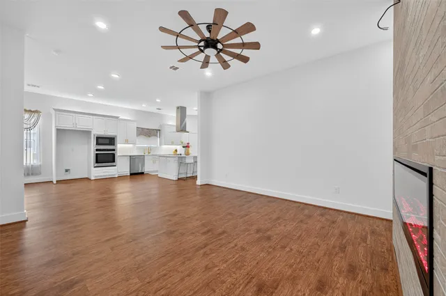 a view of kitchen and livingroom with furniture wooden floor