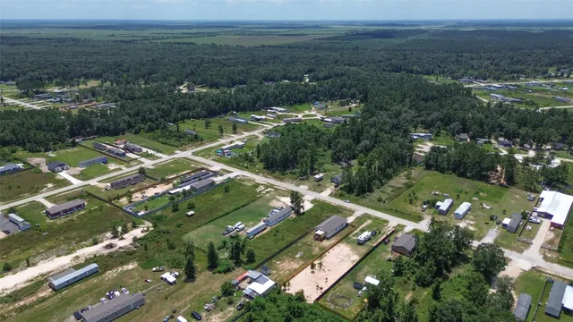 an aerial view of city lake and trees