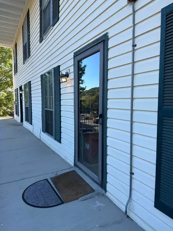 a view of a porch with a door and a window