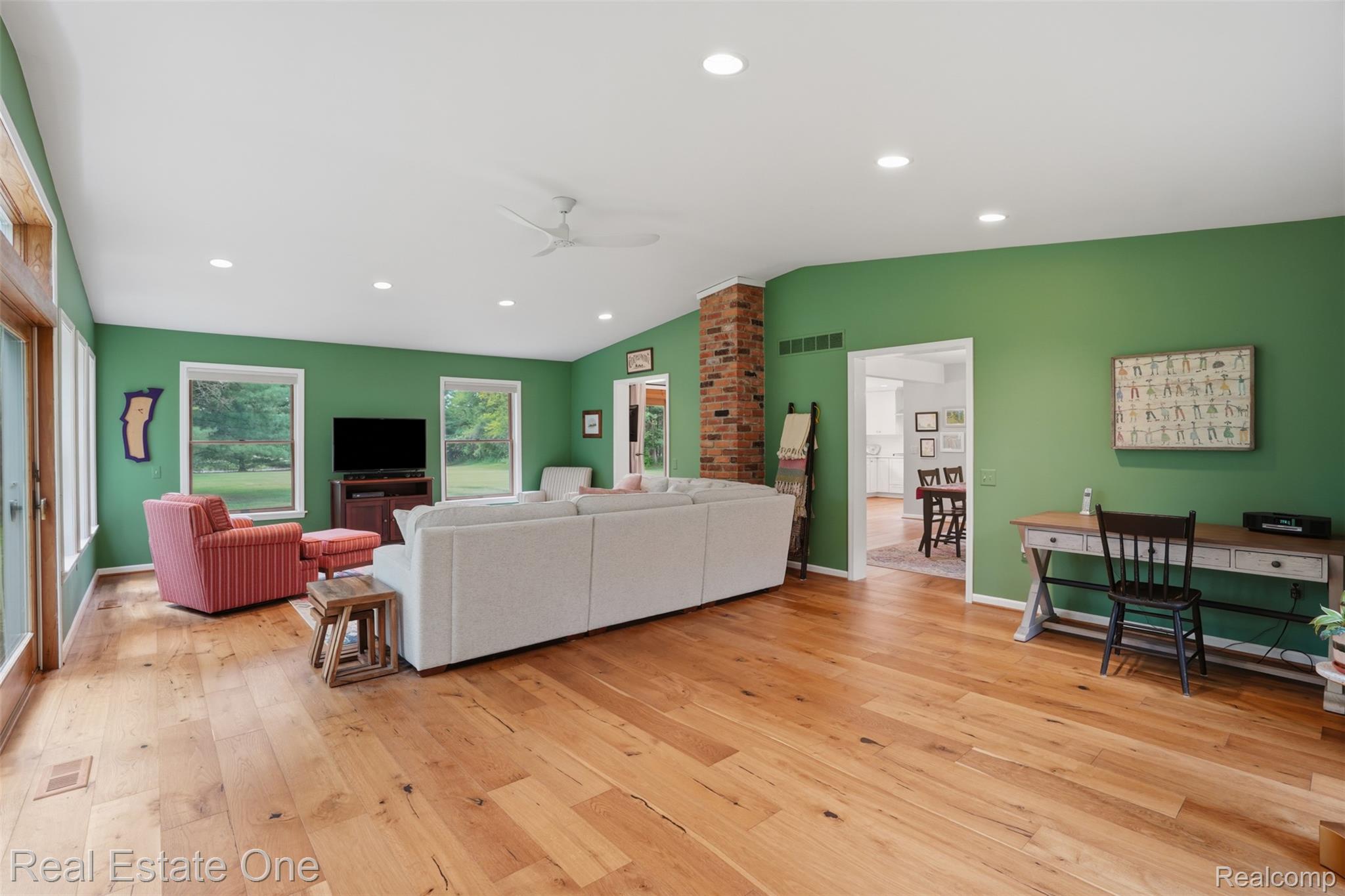 1765 Rowe Road Milford, MI 48380 - Photo 21 of 61 Spacious living area featuring wood-finish flooring, recessed lighting, and a prominent brick-clad column