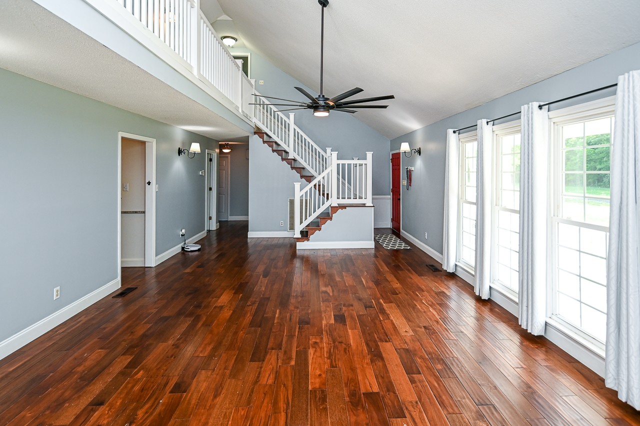 183 Lane Branch Road Fayetteville, TN 37334 - Photo 28 of 48 a view of a room with wooden floor ceiling fan and windows
